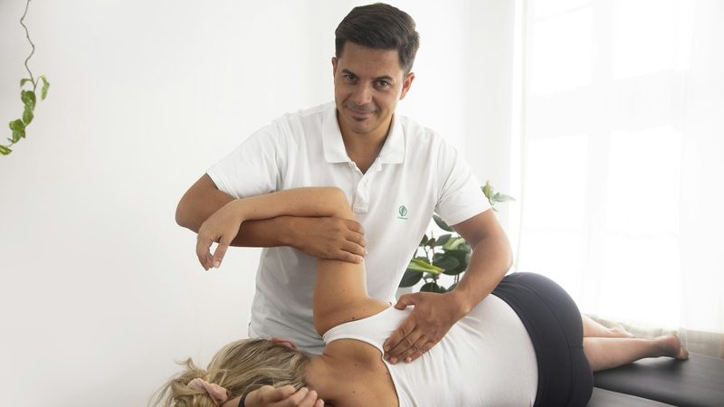 Massage therapist treating a patient's back