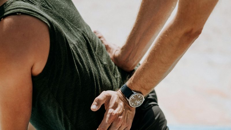 Physical therapist assisting with a stretch